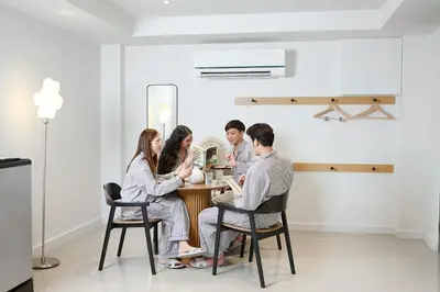 a group of people sitting at a table in a room at Livable Hotel Bangkok in Bangkok