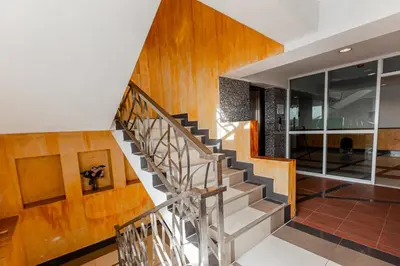 a staircase in a house with wooden walls and wooden floors at Latin Garden Hotel in Bangkok
