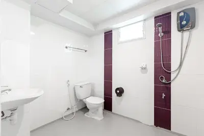 a bathroom with a toilet and a sink and a shower at Latin Garden Hotel in Bangkok