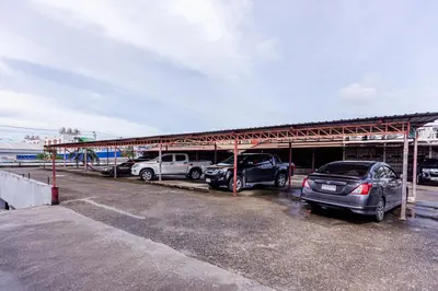 a group of cars parked in a parking lot at Latin Garden Hotel in Bangkok