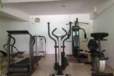 a gym with several exercise bikes and treadmills at Latin Garden Hotel in Bangkok