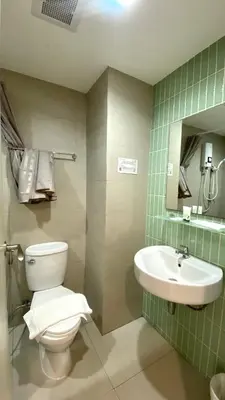 a bathroom with a toilet and a sink at POP Heritage Residence in Bangkok