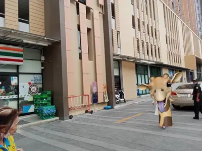 a person in a costume of a cow walking down a street at Plum central westgate@Bangyai in Ban Bang Krabu