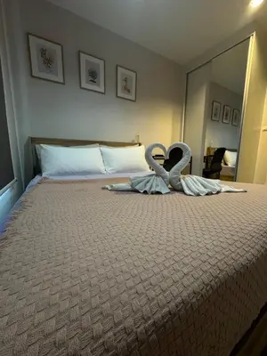 a bedroom with a bed with two swans on it at Plum central westgate@Bangyai in Ban Bang Krabu