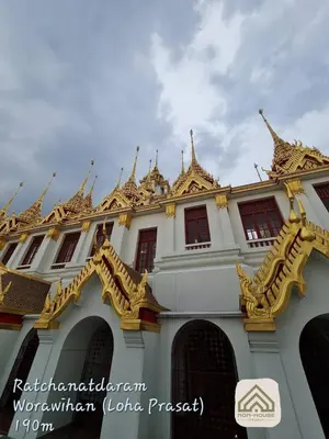 a building with golditures on top of it at Non House Bangkok บ้านนอนโฮสเทล in Bangkok