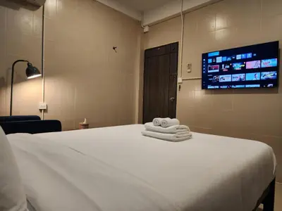 a room with a bed with towels on it at Lo-Ha Guest house, Contactless Check-in in Bangkok