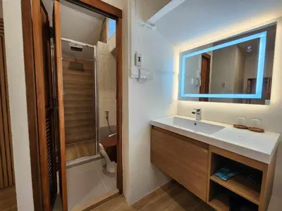 a bathroom with a sink and a mirror and a shower at Lo-Ha Guest house, Contactless Check-in in Bangkok
