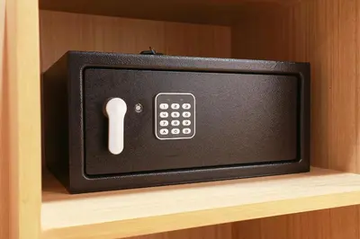 a tv on a shelf with a remote control at TAKKA Hotel - Bangna in Bangna