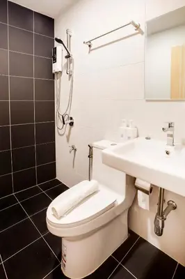 a bathroom with a toilet and a sink at TAKKA Hotel - Bangna in Bangna