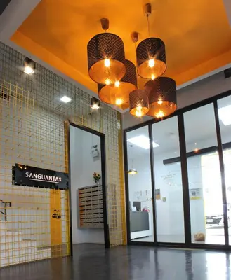 a lobby of a restaurant with a chandelier at A23 residence in Bangkok