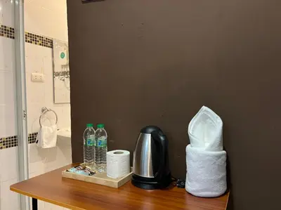 a counter with toilet paper and water bottles on it at Cozy rooms Asoke in Bangkok