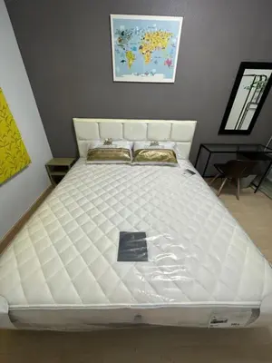 a bed in a room with a white mattress at S Villa @Impact Muangthongthani in Pak Kret