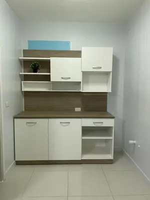 a kitchen with white shelves and white cabinets at S Villa @Impact Muangthongthani in Pak Kret