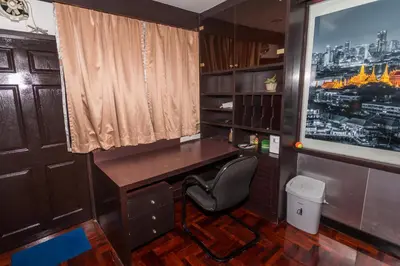 a home office with a desk and a chair at Flourish Apartments in Bangkok