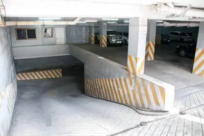 a parking lot with cars parked in a parking garage at S.K. Residence in Bangkok