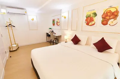 a bedroom with a large white bed in a room at Rose Apple Hotel in Bangkok