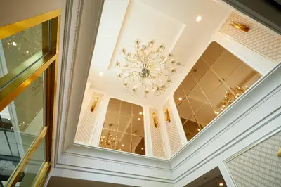 a ceiling with a chandelier in a room at Rose Apple Hotel in Bangkok