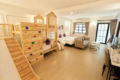 a living room with a rock climbing wall at Rose Apple Hotel in Bangkok