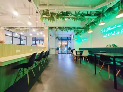 a restaurant with tables and chairs and a bar at Ostay Asoke Bangkok in Makkasan