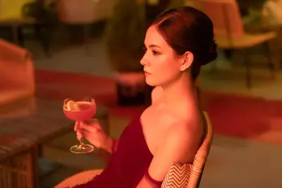 a woman sitting in a chair holding a wine glass at The Gravitique Hotel Khaosan in Bangkok