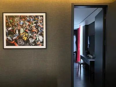 a painting hanging on a wall in a bathroom at The Gravitique Hotel Khaosan in Bangkok