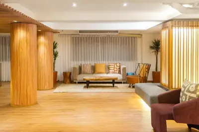 a living room with a couch and a table at Arck Hotel in Bangkok