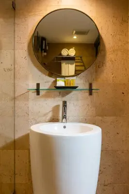 a bathroom with a sink and a mirror at Arck Hotel in Bangkok