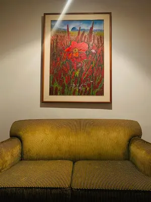 a couch in a room with a painting on the wall at Cafe ice resident in Yan Nawa