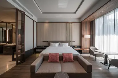 a hotel room with a bed and a couch at Villa Deva Resort & Hotel Bangkok in Bangkok