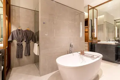 a bathroom with a tub and a shower and a sink at Villa Deva Resort & Hotel Bangkok in Bangkok