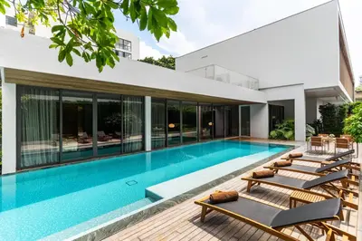 a swimming pool in the backyard of a house at Villa Deva Resort & Hotel Bangkok in Bangkok