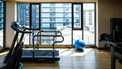 a gym with a view of a large window at Wellness Stay & Hotel Sukhumvit 107 in Bangna