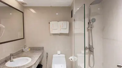 a bathroom with a shower and a toilet and a sink at C Hotel Bangna in Bangkok