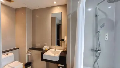 a bathroom with a sink and a shower at C Hotel Bangna in Bangkok