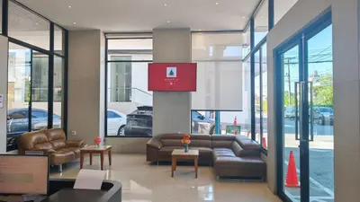 a lobby with couches and tables in a building at C Hotel Bangna in Bangkok
