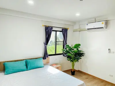 a bedroom with a bed and a window at GP House Bangkok - Sukhumvit Onnut BTS Skytrain in Bangkok