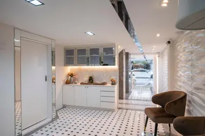 a kitchen with a sink and a table and chairs at Masa Hotel فندق الماسة شارع العرب in Bangkok