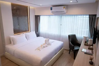a hotel room with a bed with a towel on it at Masa Hotel فندق الماسة شارع العرب in Bangkok
