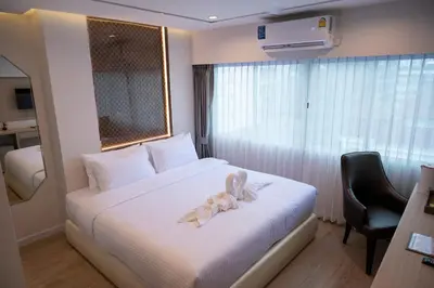 a hotel room with a bed with a bow on it at Masa Hotel فندق الماسة شارع العرب in Bangkok