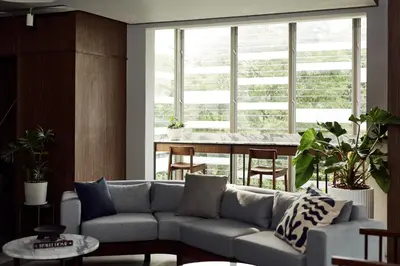 a living room with a couch and a table at Casa 17 Hotel Bangkok in Bangkok
