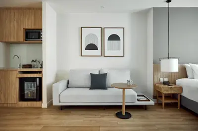 a living room with a couch and a bed at Casa 17 Hotel Bangkok in Bangkok