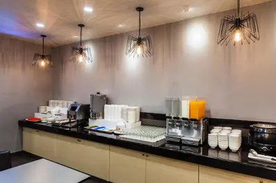a restaurant with a counter with food and drinks at Livotel Hotel Lat Phrao Bangkok in Bangkok