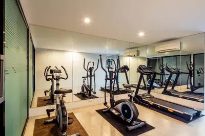 a gym with several treadmills and exercise bikes at Livotel Hotel Lat Phrao Bangkok in Bangkok