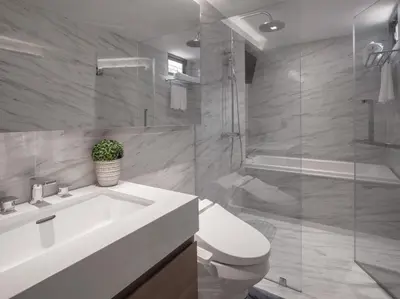 a bathroom with a sink and a toilet and a shower at VOQUE Hotel & Serviced Residence Sukhumvit 51 in Bangkok