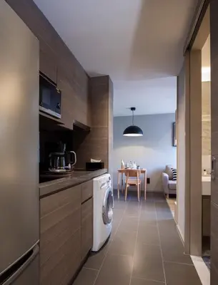 a kitchen with a washer and dryer in a room at VOQUE Hotel & Serviced Residence Sukhumvit 51 in Bangkok