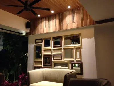 a living room with a couch and a ceiling fan at UMA Residence in Bangkok