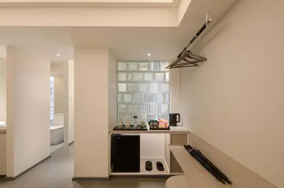 a room with a wall with a counter with baseball bats at YANH Ratchawat Hotel in Bangkok