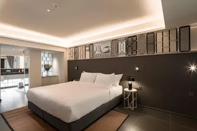 a bedroom with a large white bed in a room at YANH Ratchawat Hotel in Bangkok