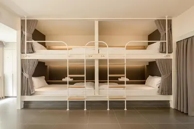a room with bunk beds in a house at YANH Ratchawat Hotel in Bangkok