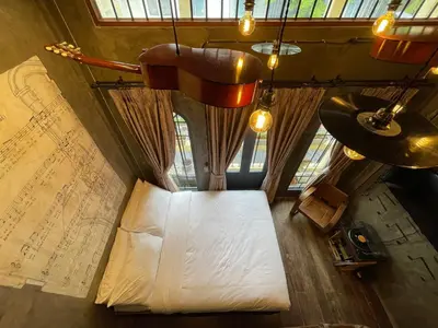 a bedroom with a bed and a large map at Central Old Town Cottage in Bangkok